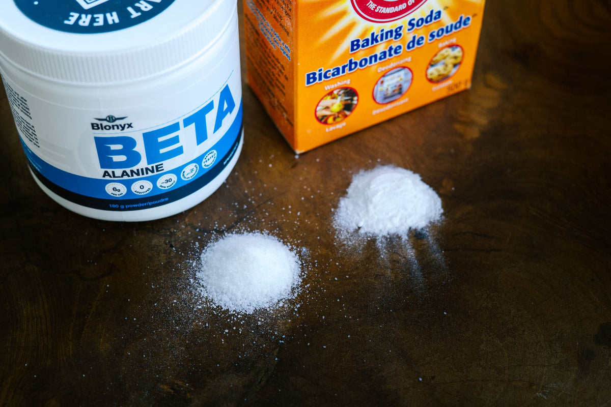 Beta Alanine and Baking Soda containers and piles of powder