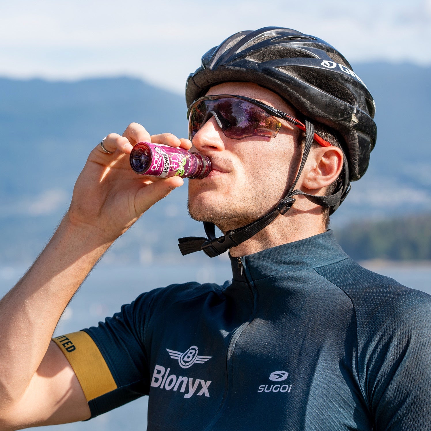 Cyclist drinking a Beet It Sport Nitrate 400 shot