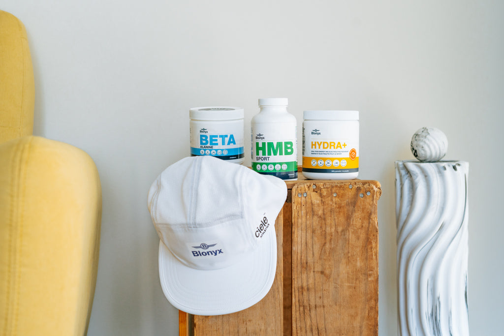 Three Blonyx products and a Blonyx hat sitting on an end table beside a couch