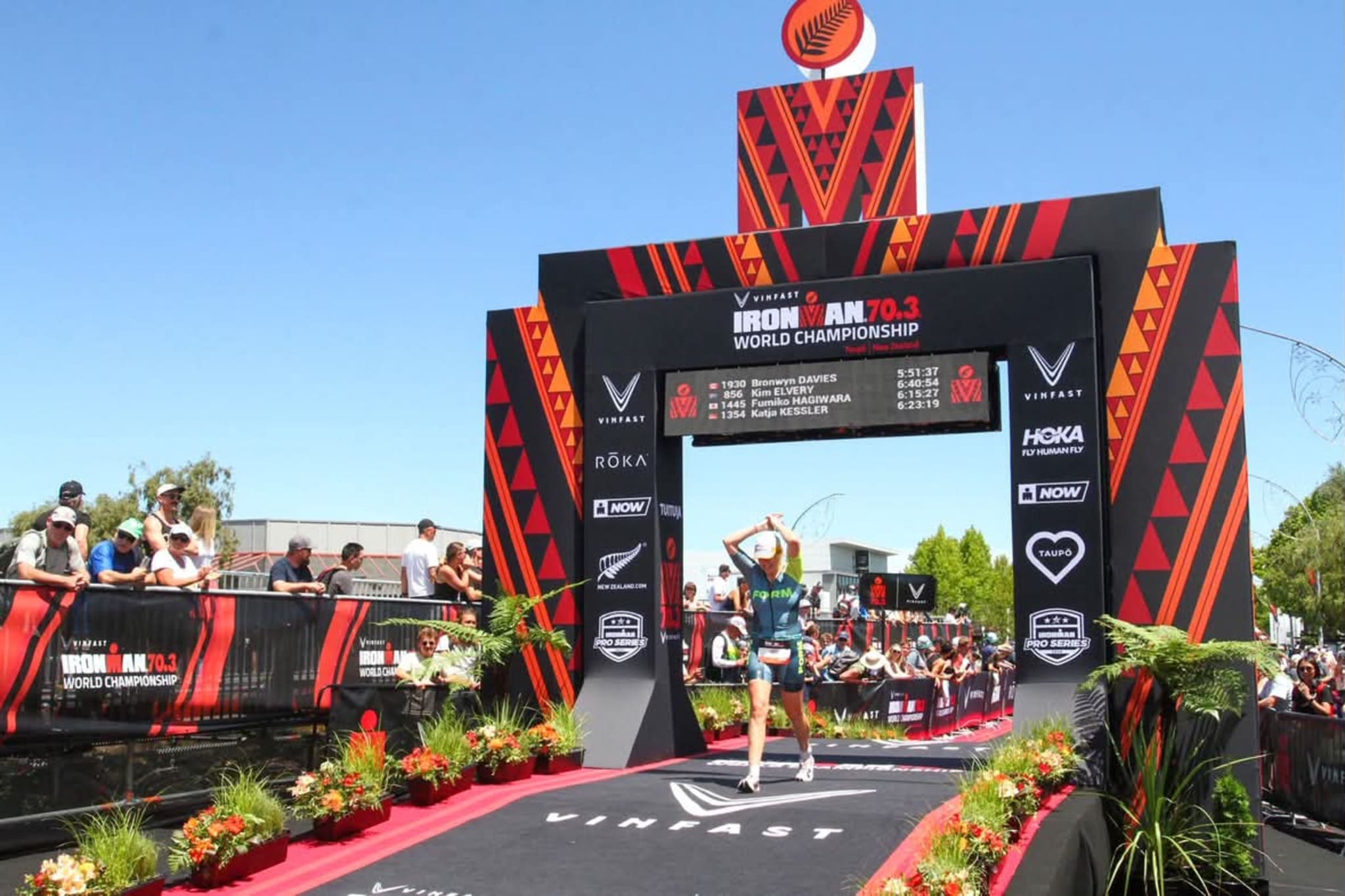 Bronwyn crossing the finish line at an ironman