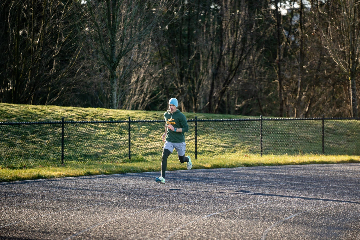 A Blonyx Athlete Runs Around a Track