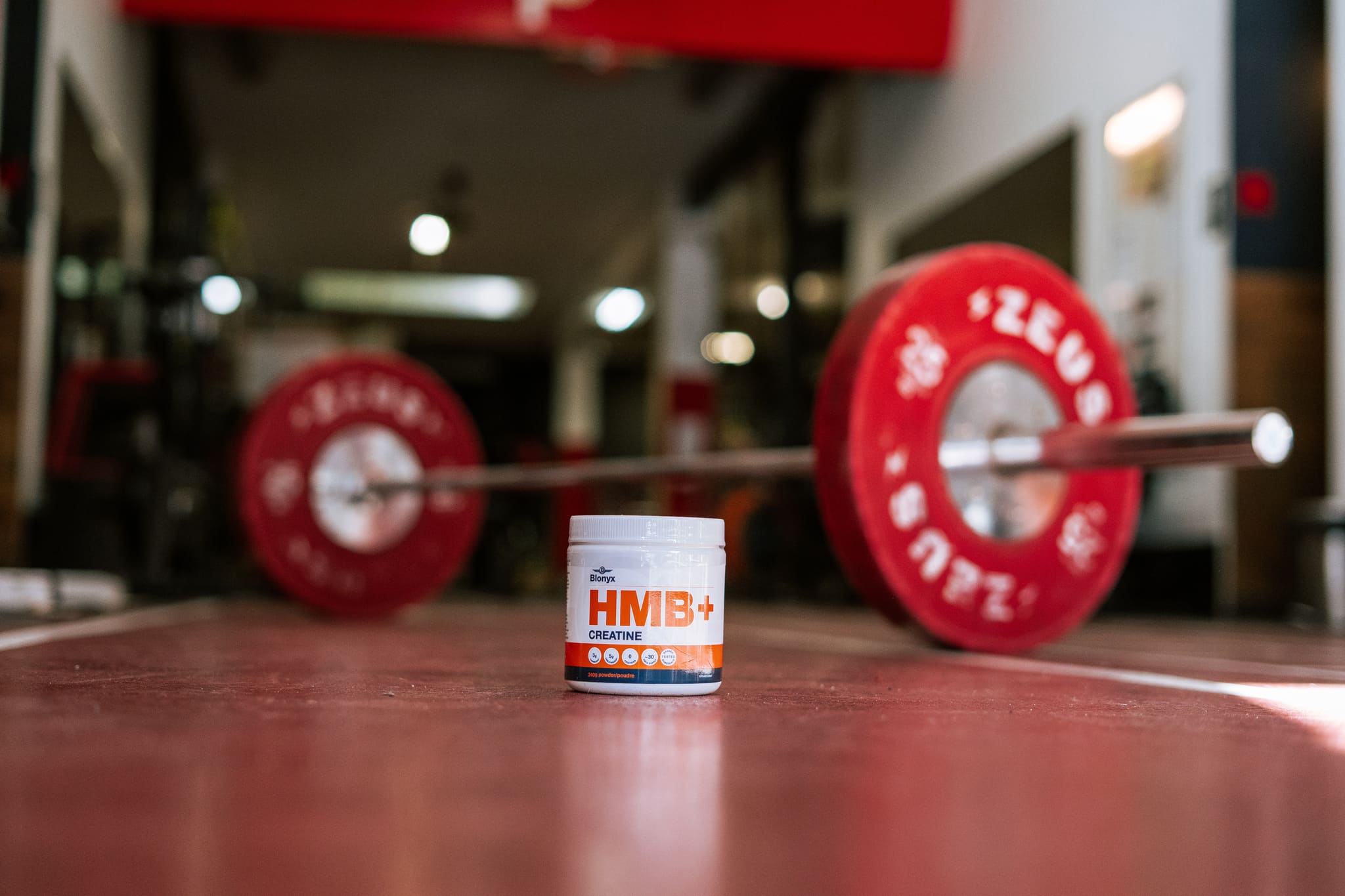 Blonyx HMB+ Creatine in a Gym with a Barbell