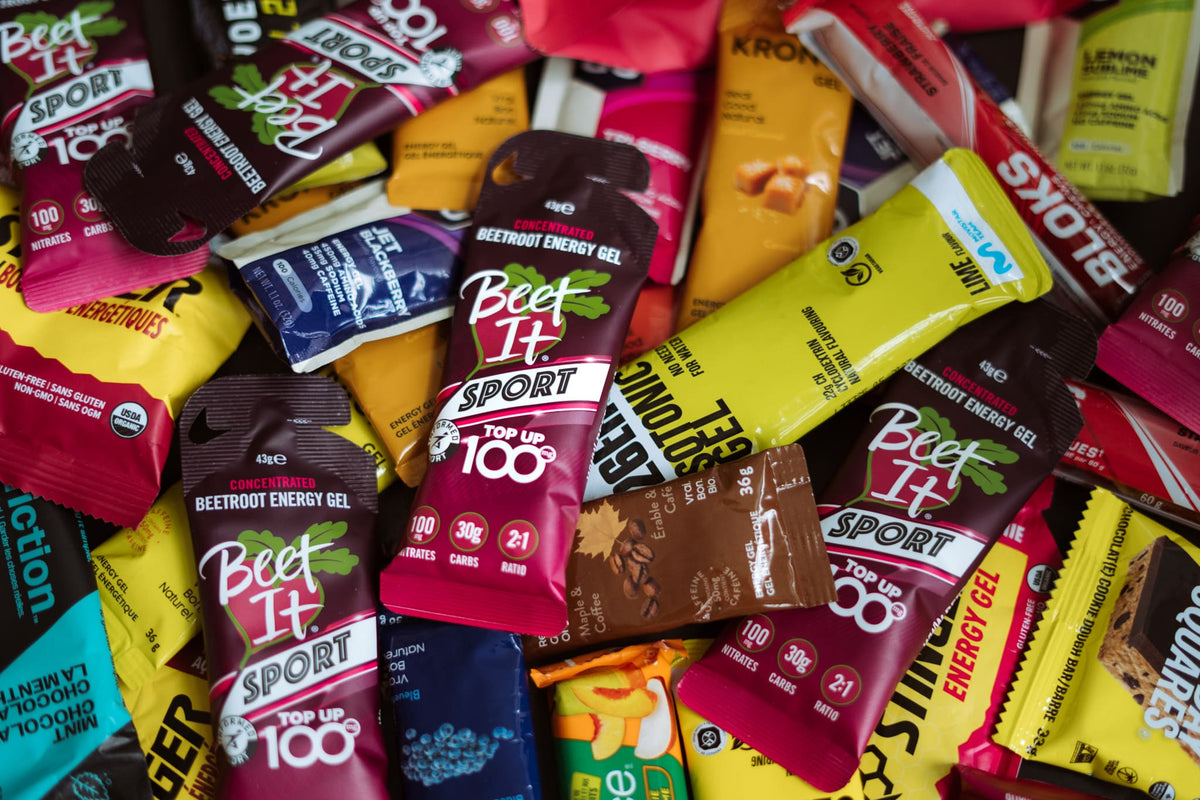 Beet It Sport Top Up 100 Energy Gel surrounded by more Gels and Endurance Fuel