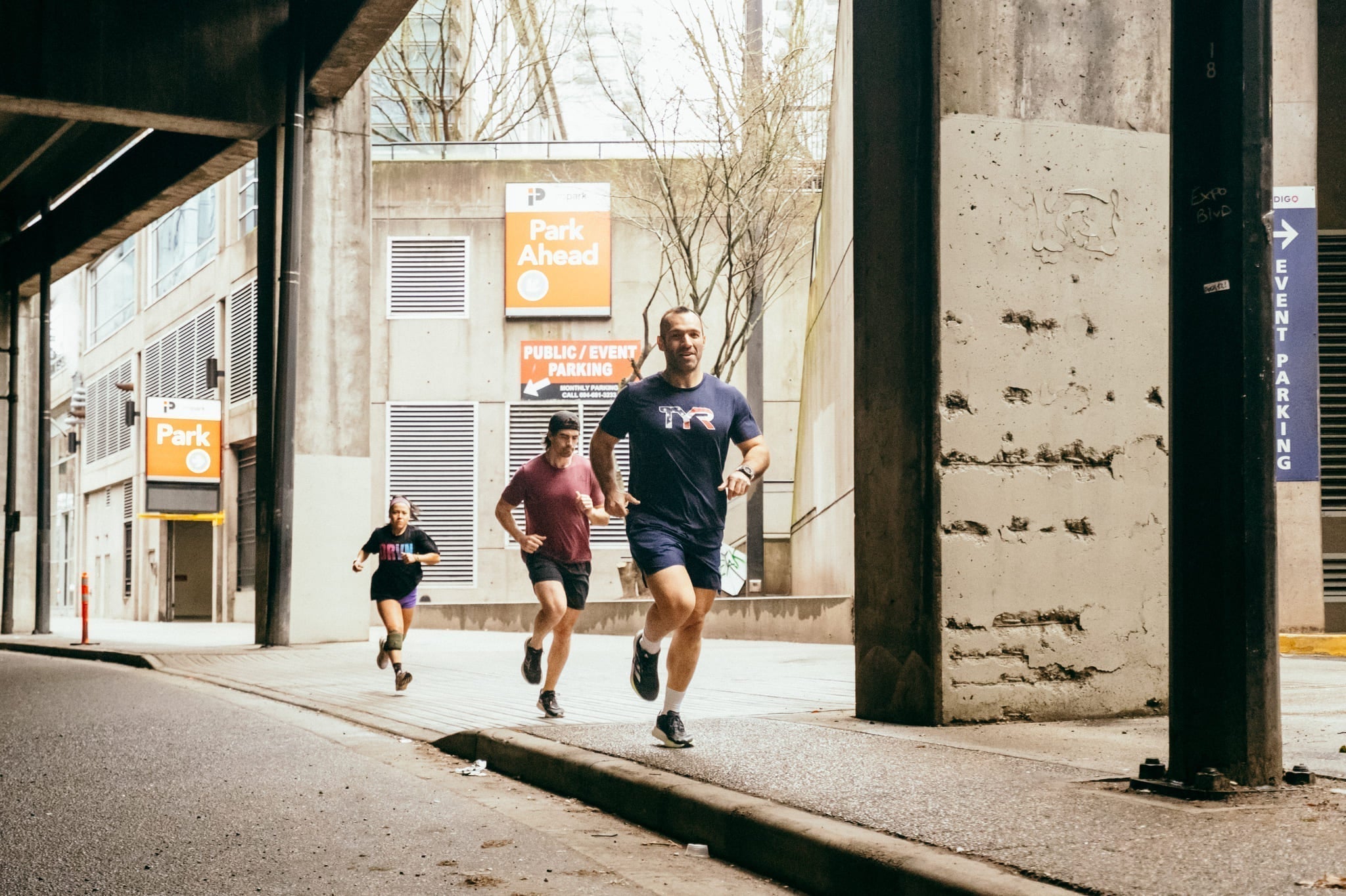 three runners in an urban environment