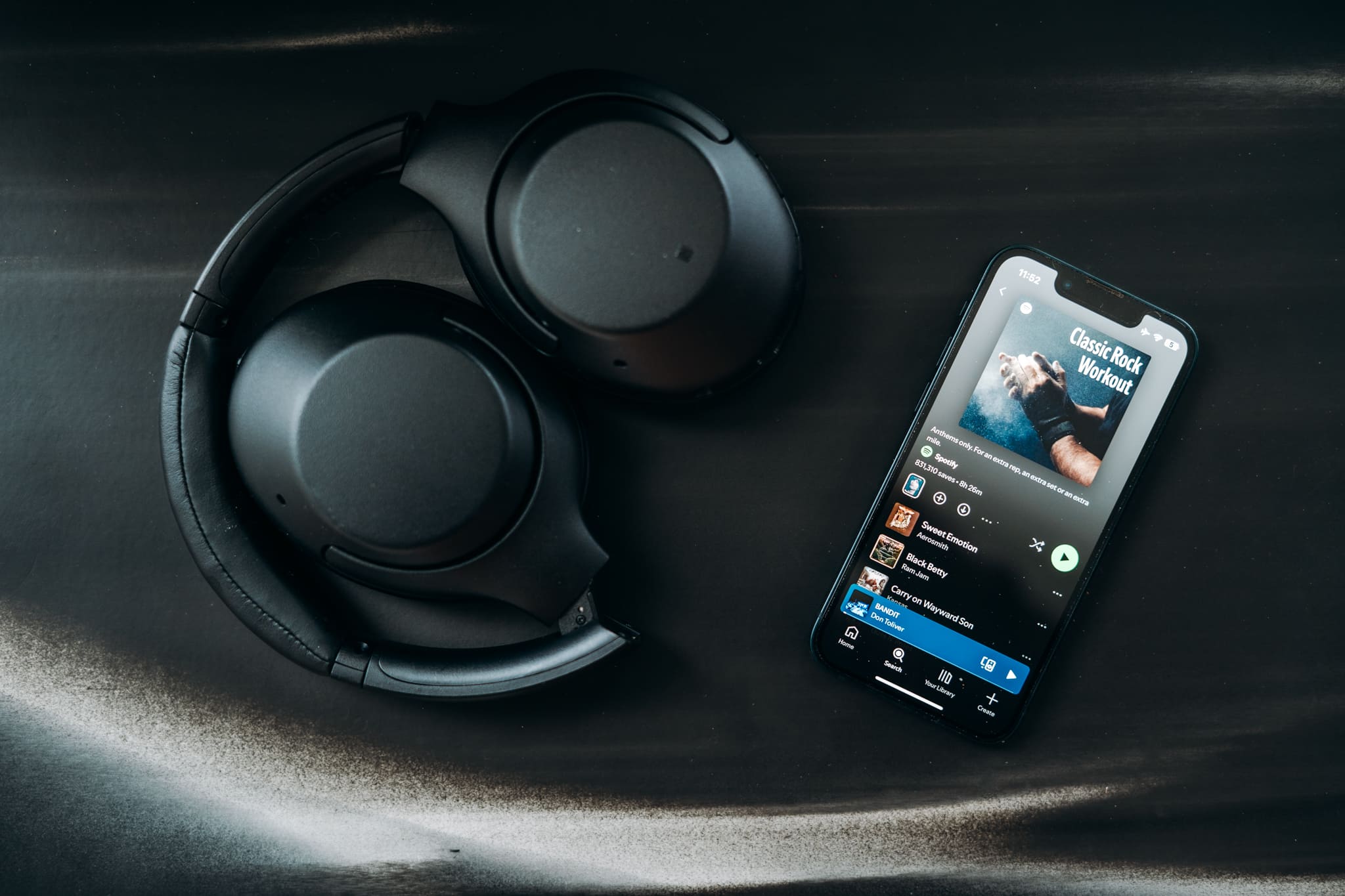 Headphones and an open music app on a phone