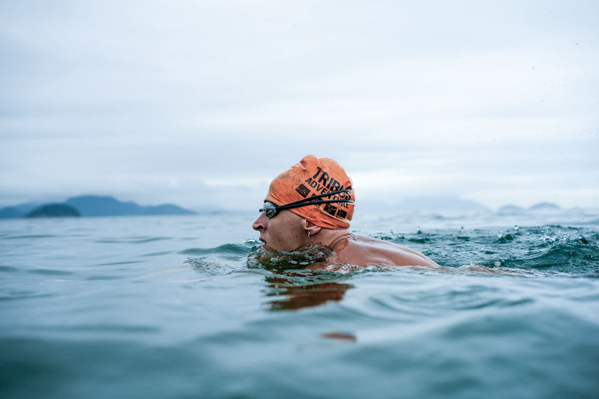 Open water swimmer in an orange swim cap