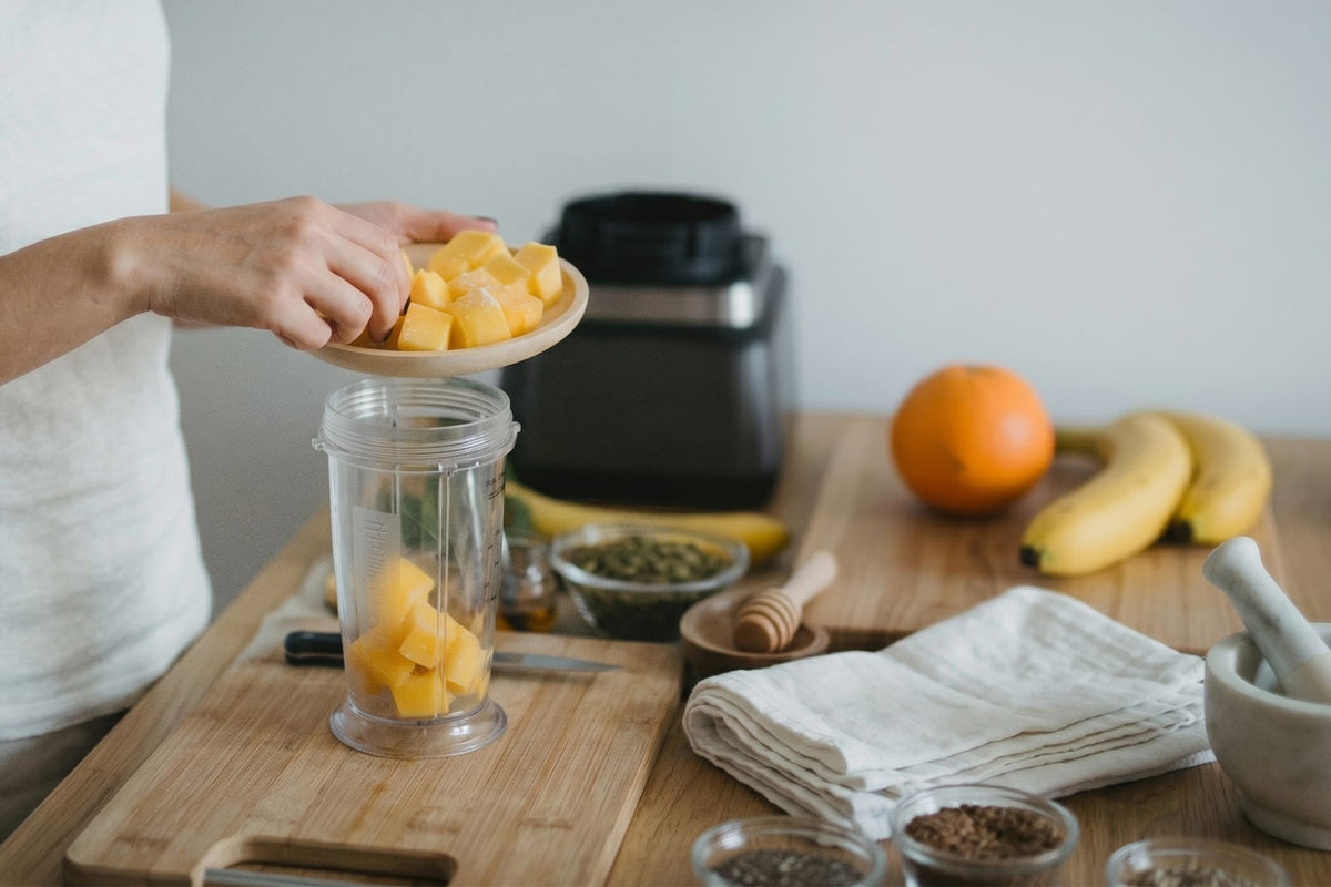 Someone making a fruit smoothie