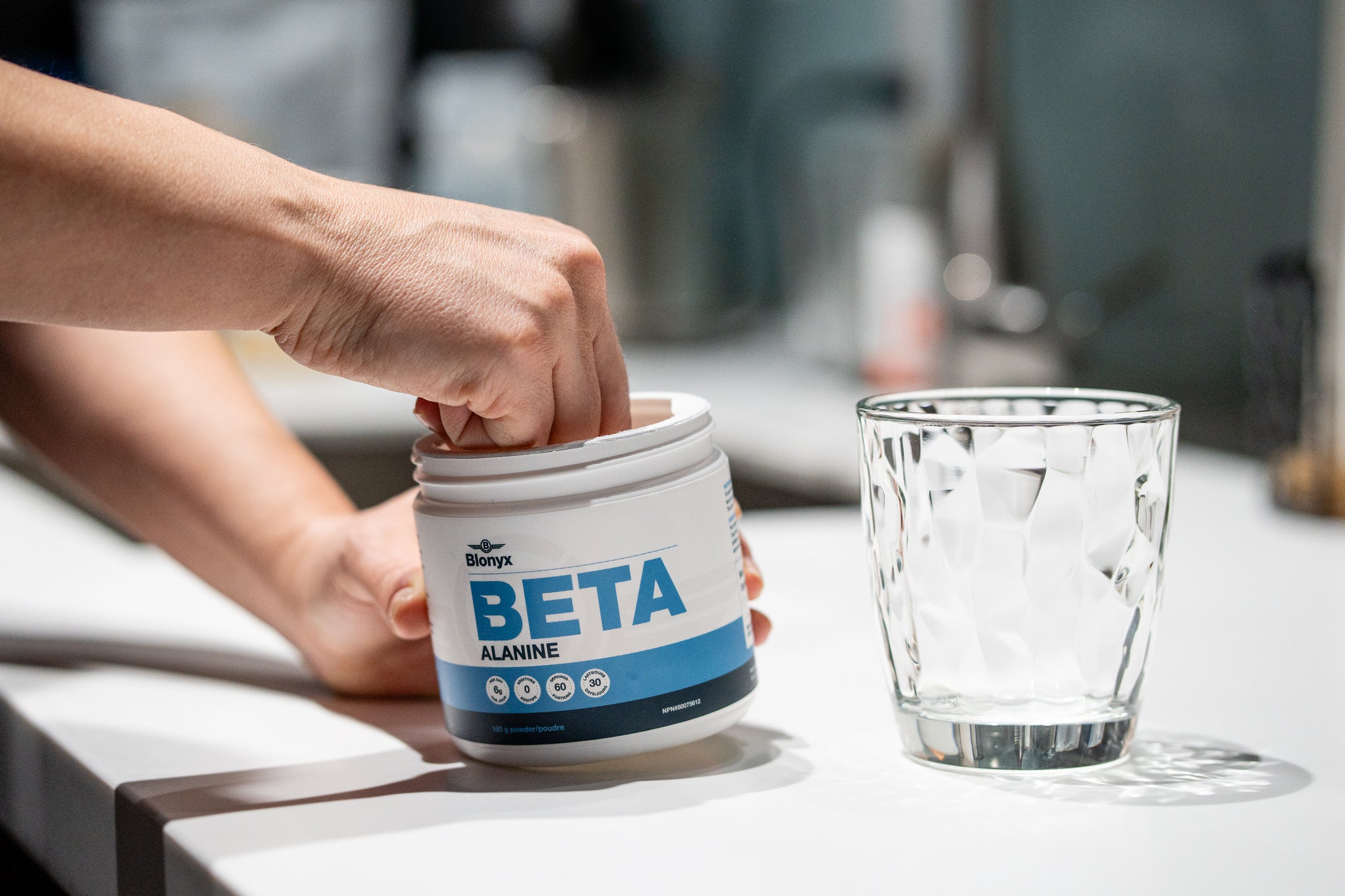 Person scooping Blonyx Beta Alanine into a glass