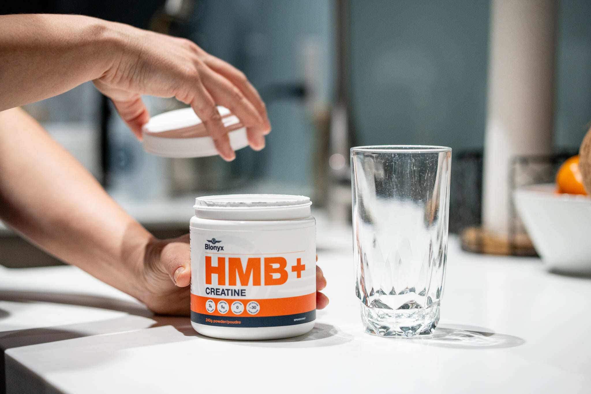 Athlete Removing the Lid of Blonyx HMB+ Creatine