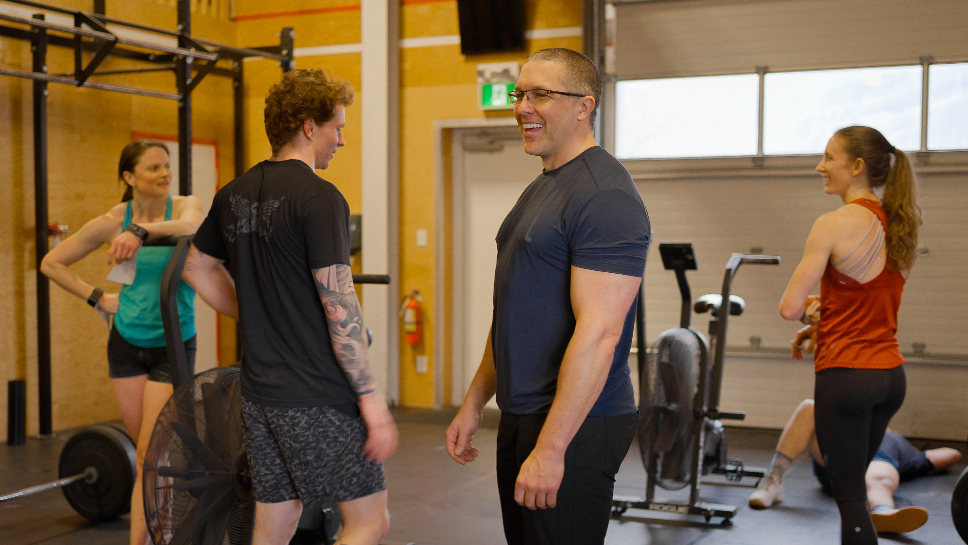 People enjoying conversation in a CrossFit gym