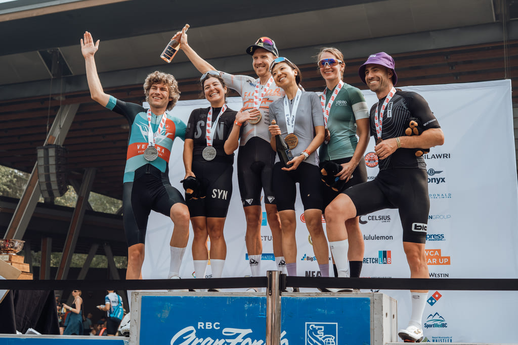 Cyclists celebrating on the podium at the RBC GranFondo Whistler