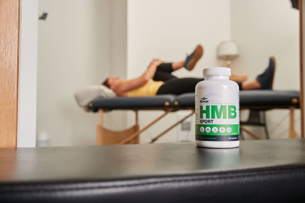 Physiotherapy clinic with Blonyx HMB Sport recovery supplement on treatment table for muscle recovery and rehabilitation