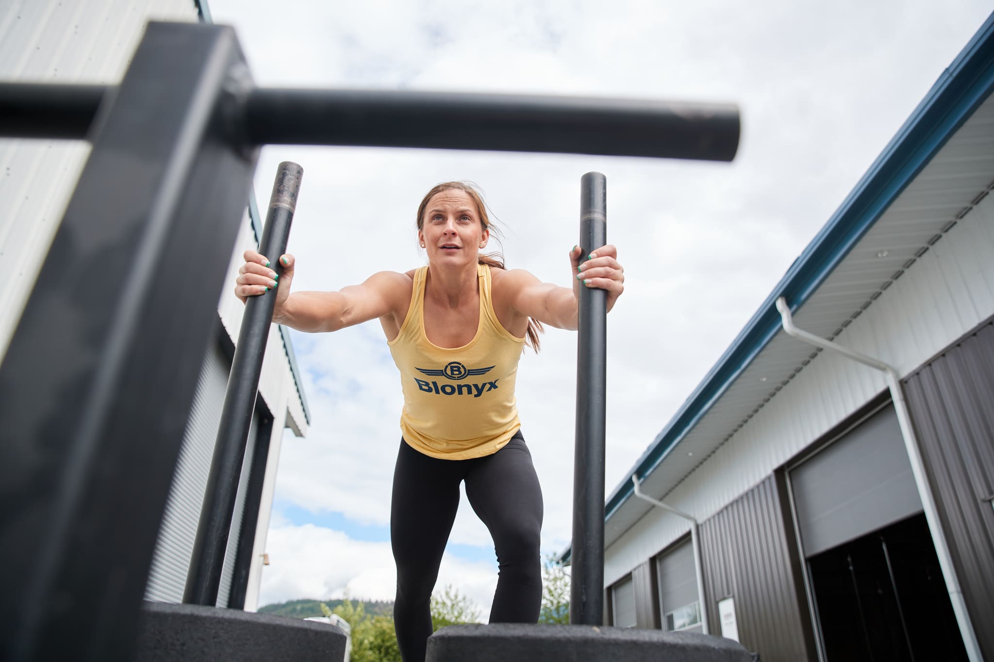 Athlete Pushing a Sled Wearing a Blonyx Singlet