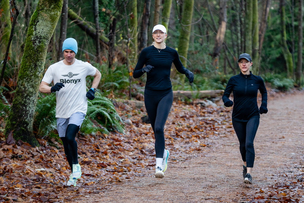 Group of runners training on a forest trail to improve endurance, aerobic fitness, and running performance.