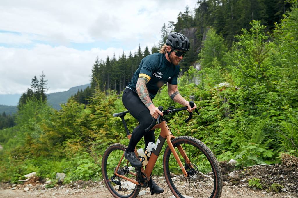 Mountain biker climbing a gravel trail.
