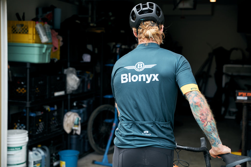 A Cyclist in a Blonyx Kit Enters a Garage