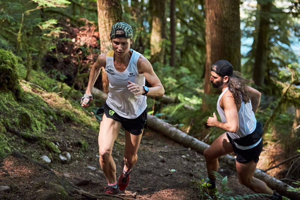 Two trail runners scaling a mountain.