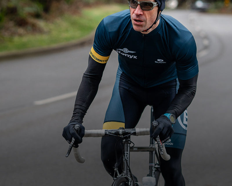 A cyclist riding on a forested road