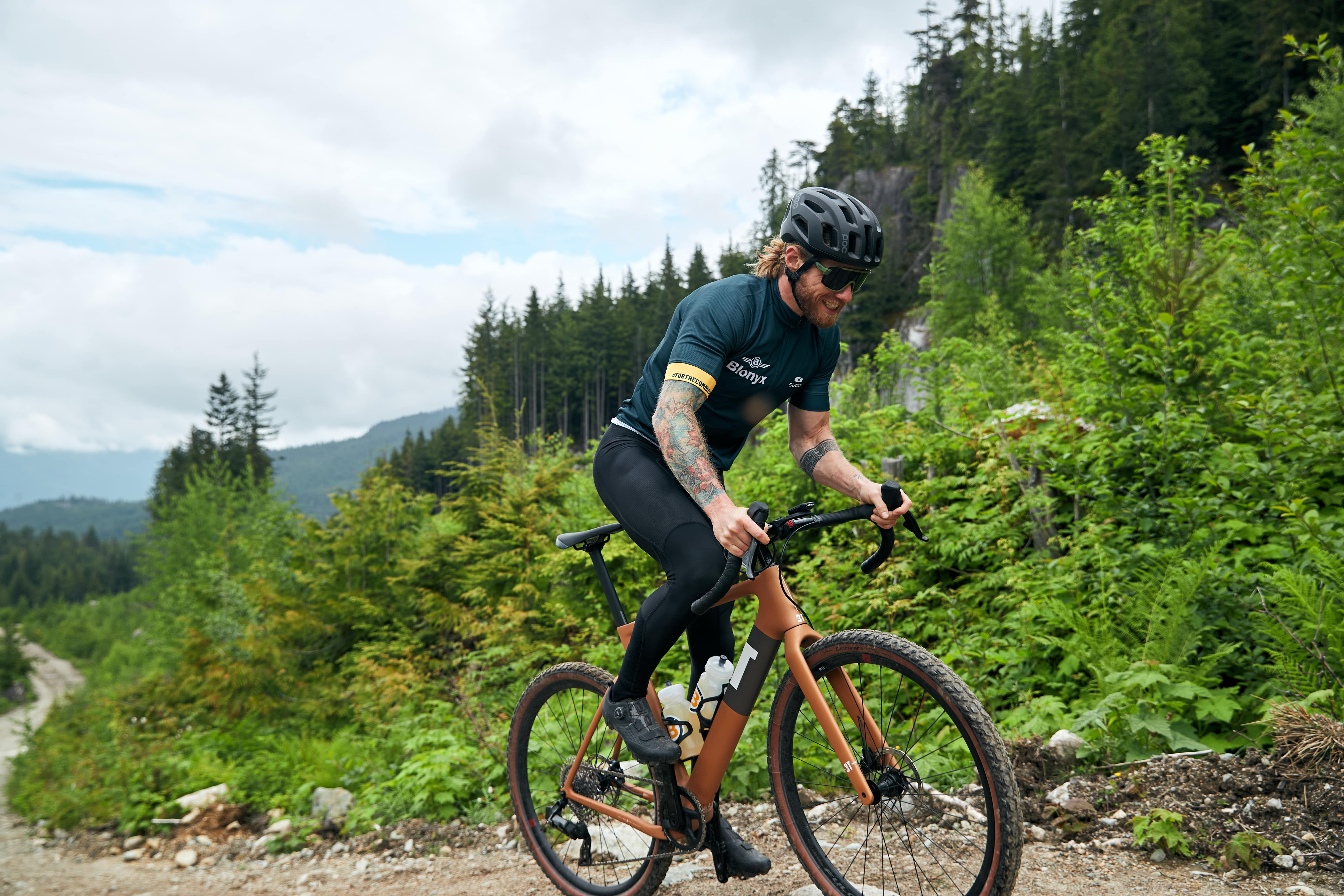 Mountain biker peddling up a steep gravel trail