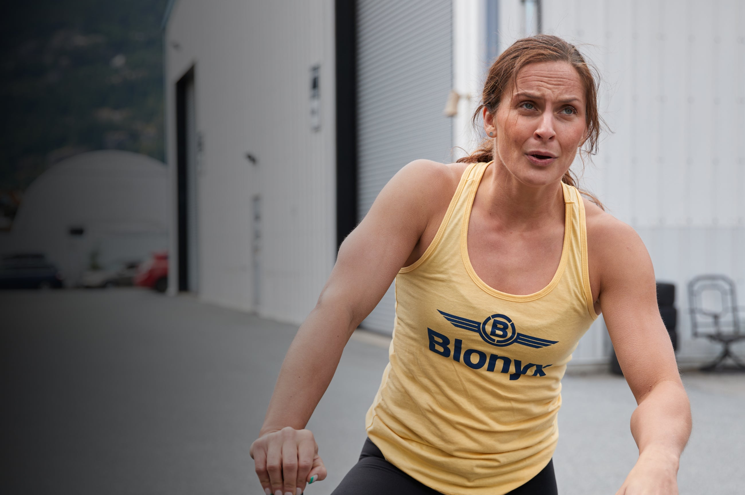 Functional athlete in a yellow Blonyx tank top