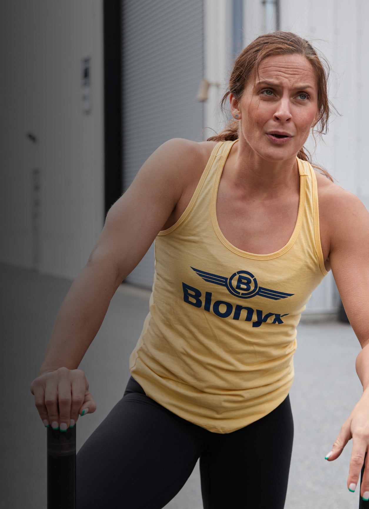 Functional athlete in a yellow Blonyx tank top