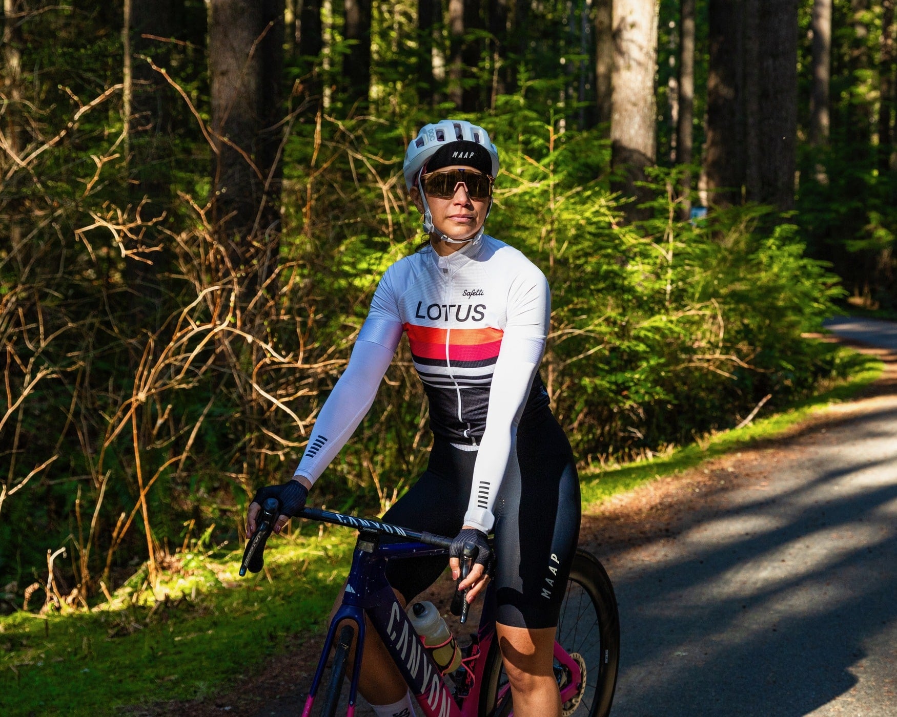 Cyclist sitting on her bike on a forest road