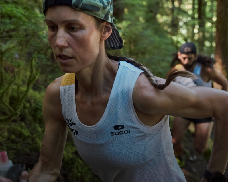 Two trail runners powering up a mountain path