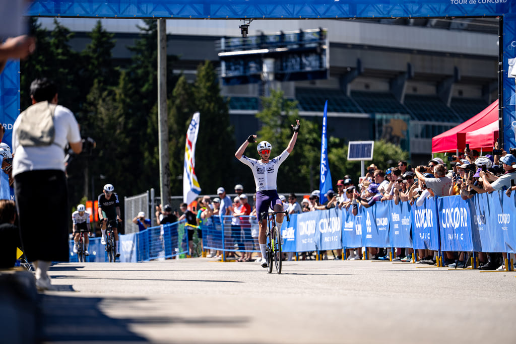 A cyclist crossing the finish line.