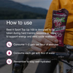 Cyclist holding Beet It Sport Top Up 100 energy gel with instructions recommending 1–2 gels per hour of exercise, water intake with each gel, and proper hydration during endurance training.